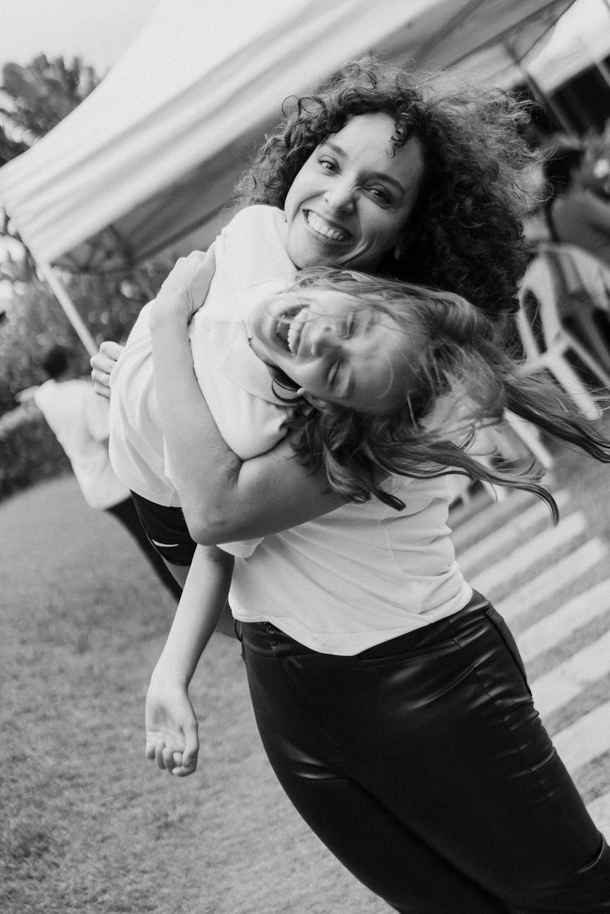 joyful outdoor mother and daughter hugging
