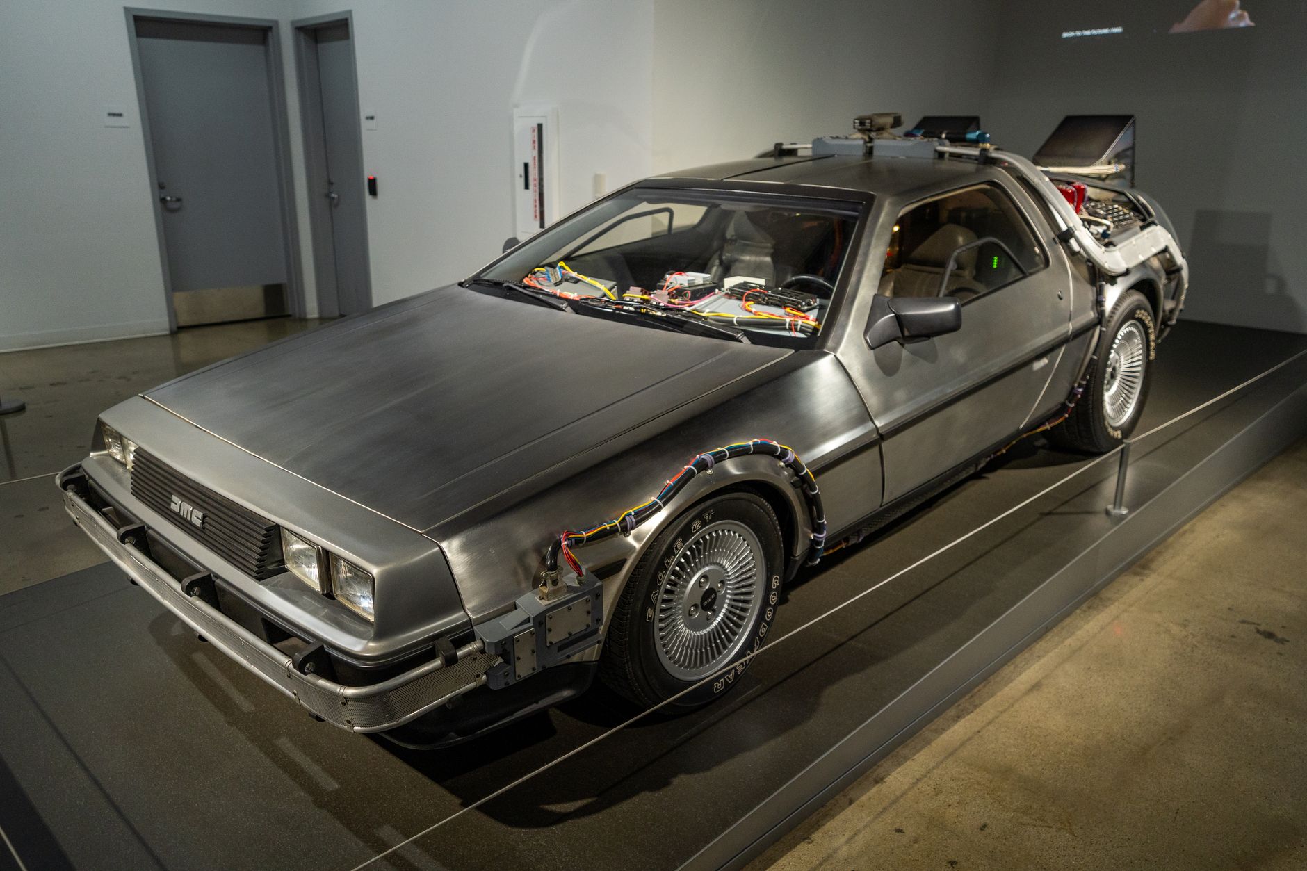 retro delorean car exhibit in museum setting