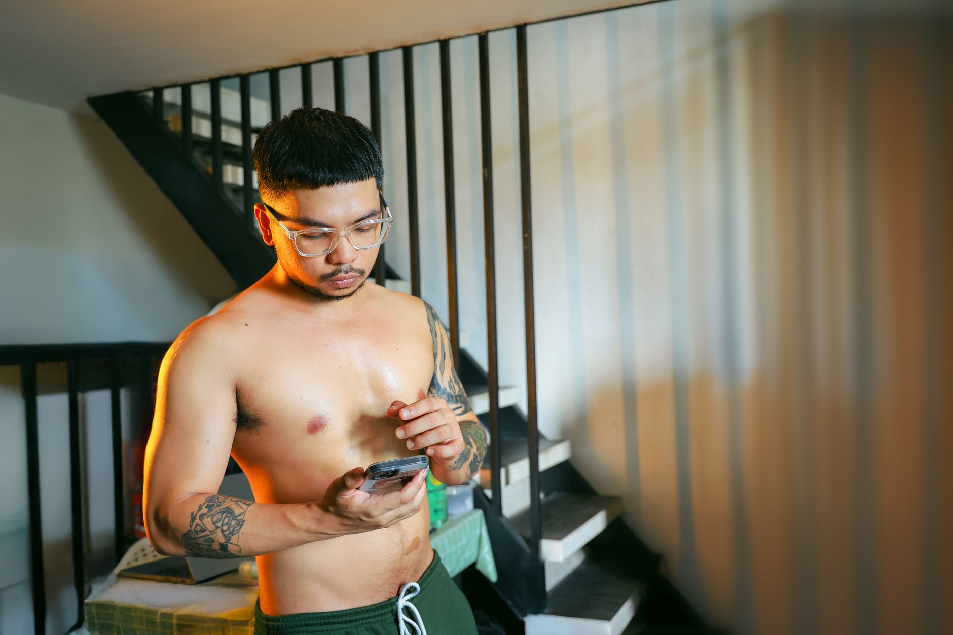 young man using smartphone by staircase